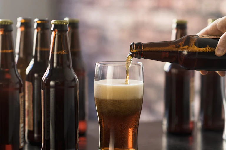 Bollte with a hand pouring beer