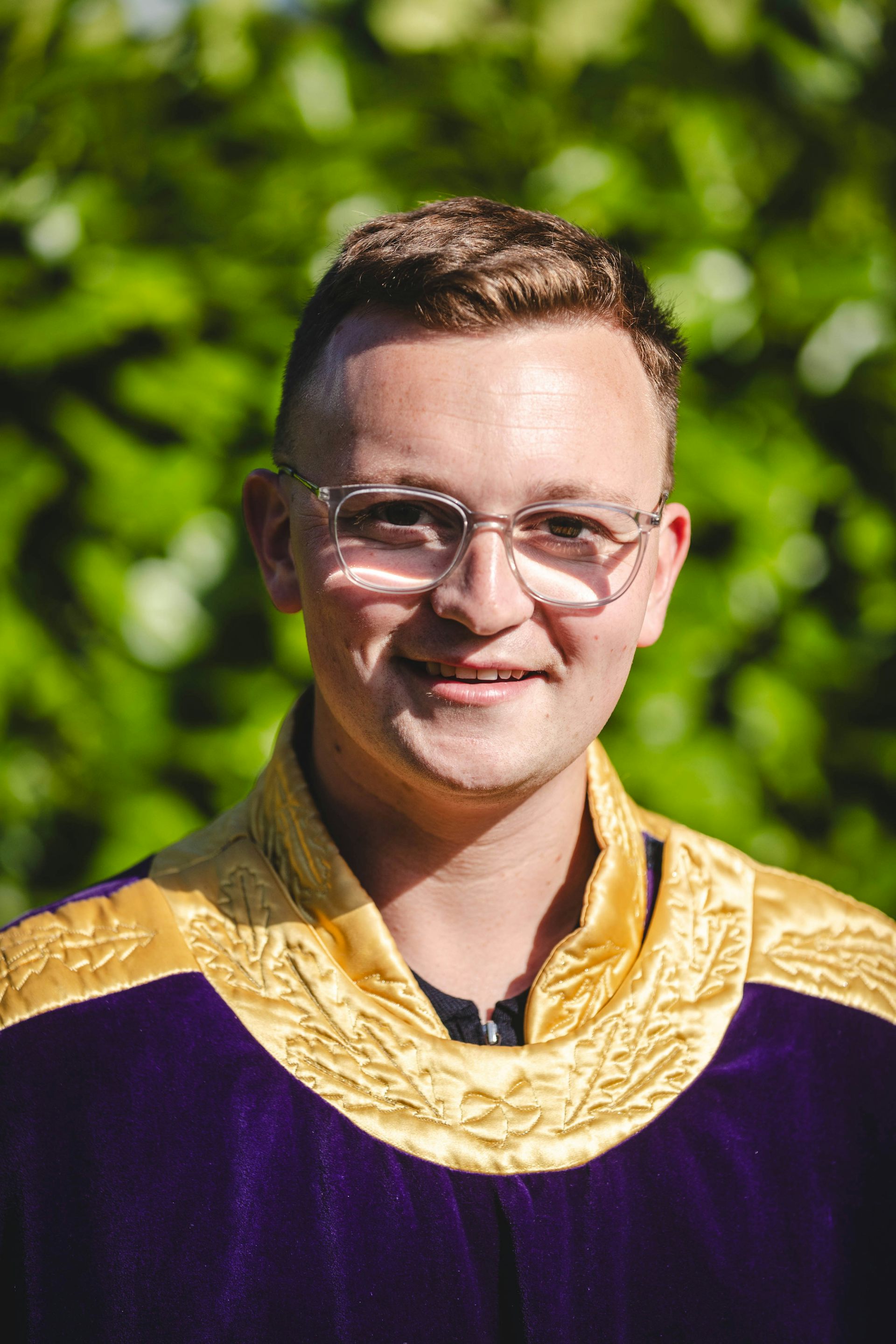 A man in purple and gold robes.