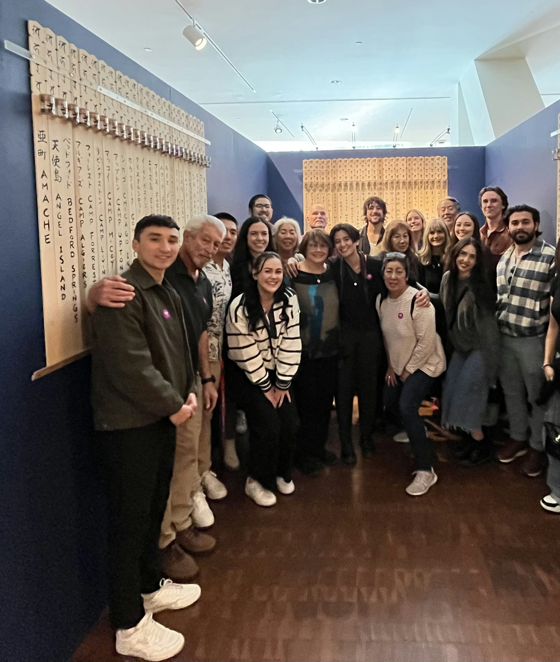 A group of people stand together for a photo.