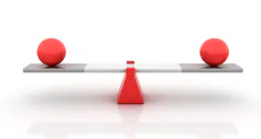 A teeter-totter with balls balanced on each platform