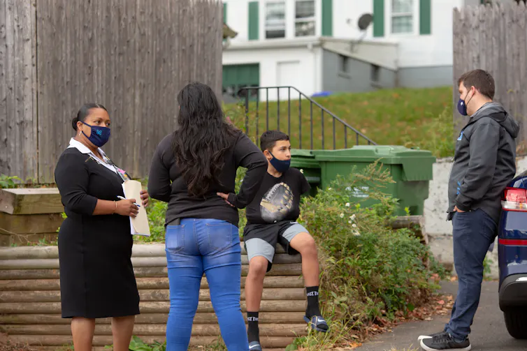 People seen outdoors in masks.