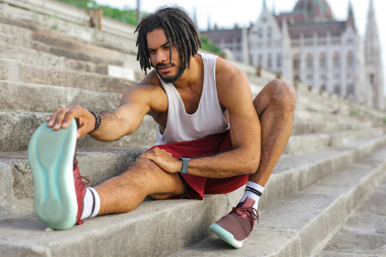 Man stretches on step