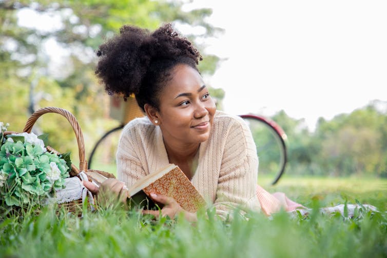 A young woman is reading a book.