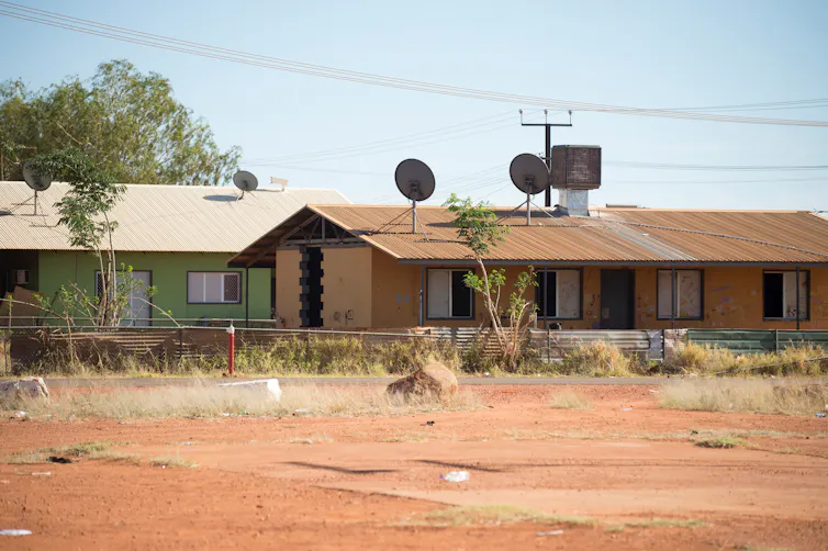 run-down homes on red earth