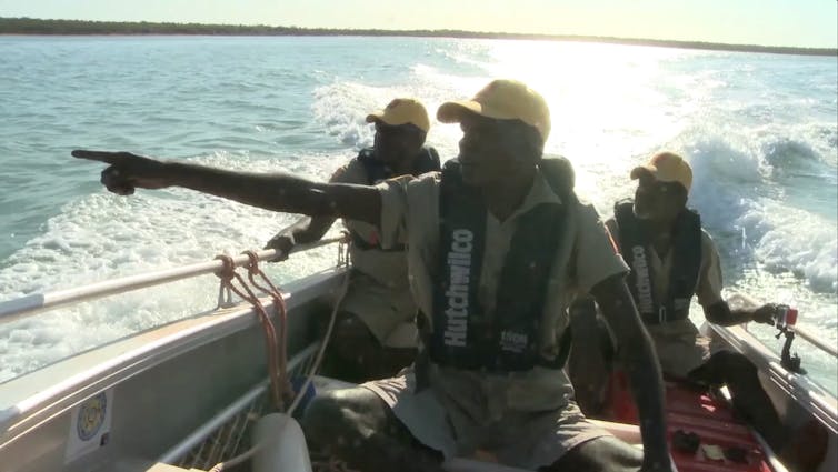 three uniformed men on a boat