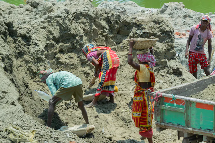 Workers digging earth.
