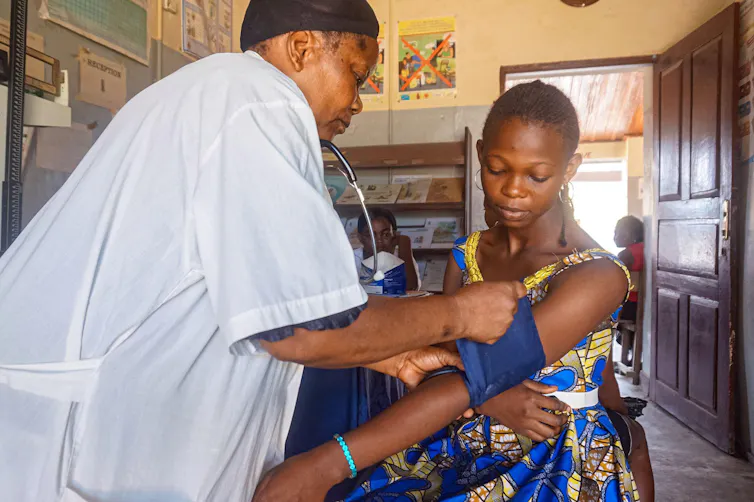A woman has her blood pressure taken at a health clinic.
