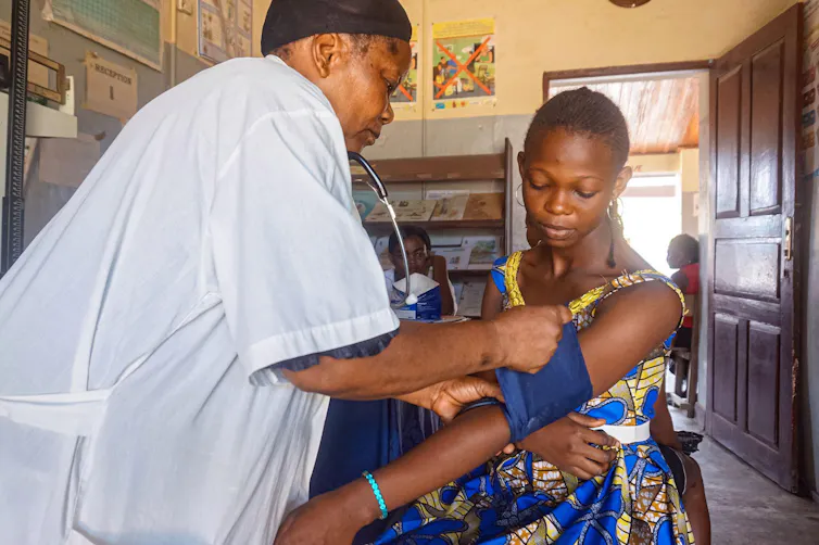 A woman has her blood pressure taken at a health clinic.