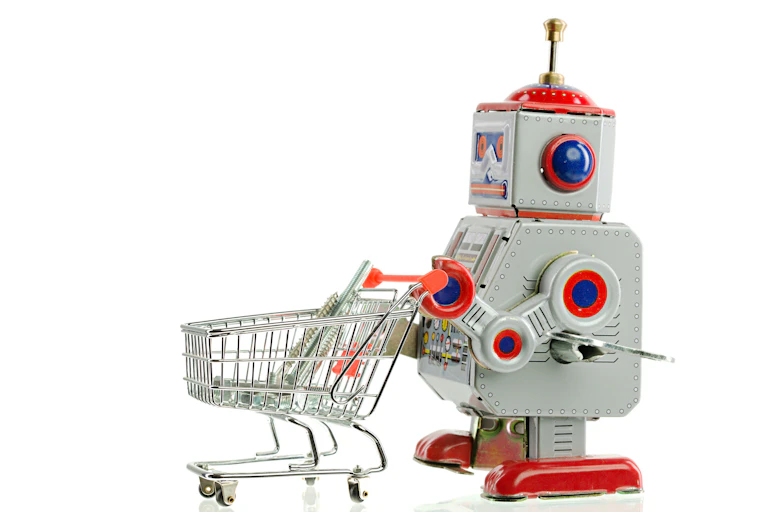 a toy robot pushes a toy shopping cart