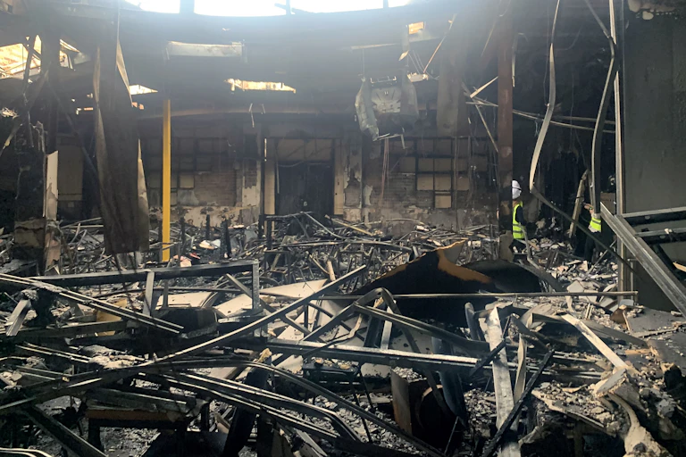 The burned wreckage of the inside of a building