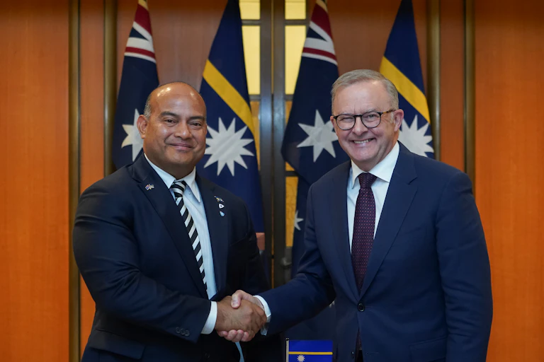 Two men in suits shaking hands