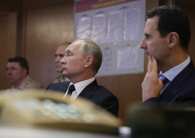 Putin and Bashar al-Assad sat next to each other during a meeting.