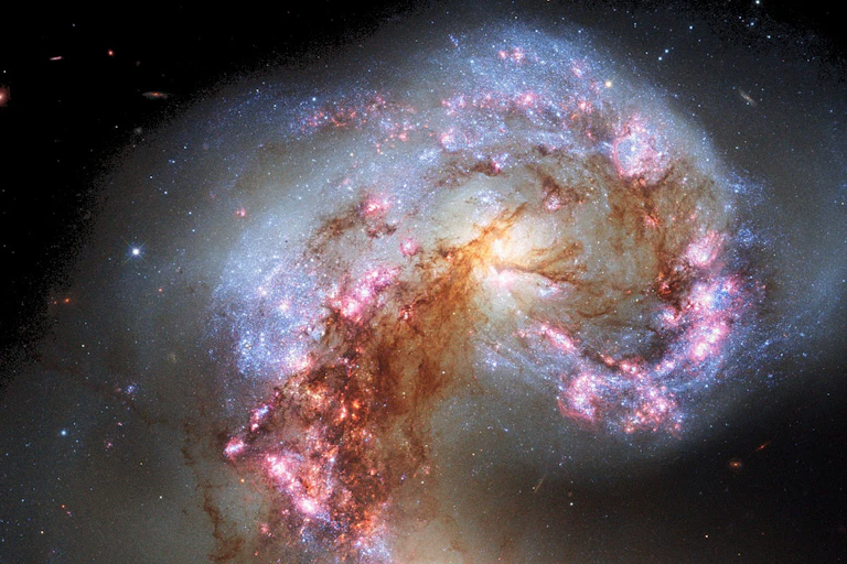 Two galaxies — also known as NGC 4038 and NGC 4039 — colliding to form an elliptical galaxy.
