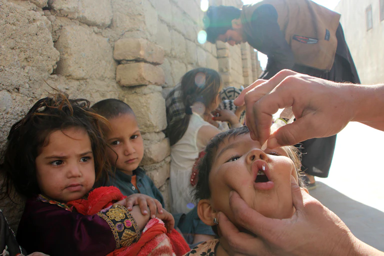 A health worker administers a polio vaccination to a child in Kandahar, Afghanistan.