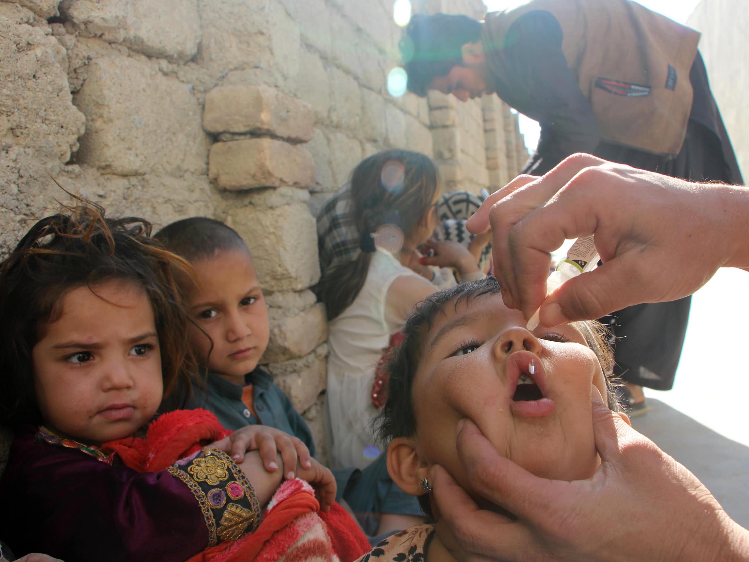 A health worker administers a polio vaccination to a child in Kandahar, Afghanistan.