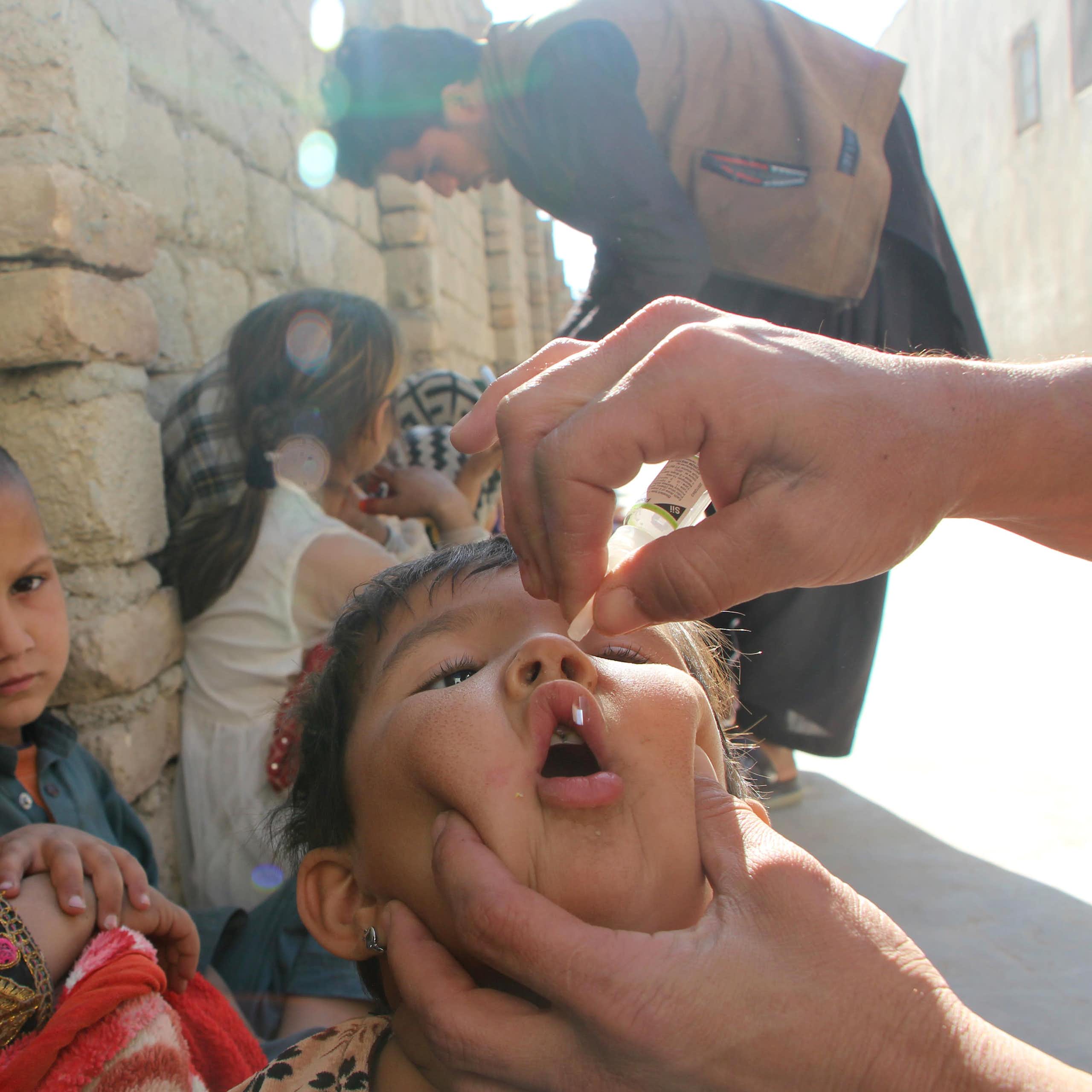 A health worker administers a polio vaccination to a child in Kandahar, Afghanistan.