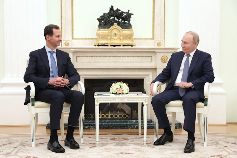 Bashar al-Assad and Vladimir Putin sitting together in a meeting room in hte Kremlin, July 2024.