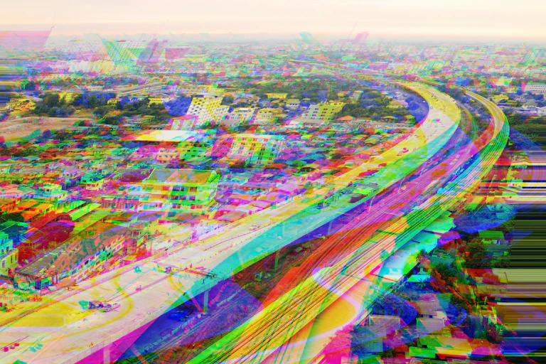 Aerial photo of a cityscape streaked with bright colours