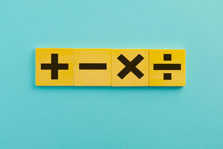 A plus, minus, multiplication and division symbol against a plain background.