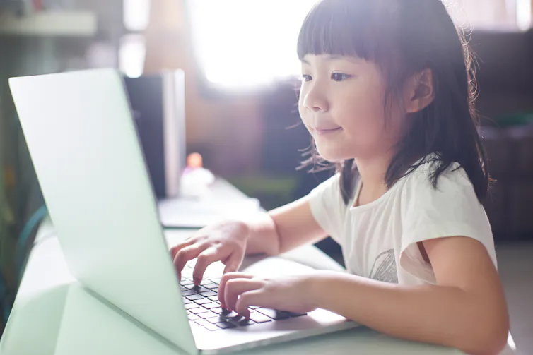 Girl plays on laptop