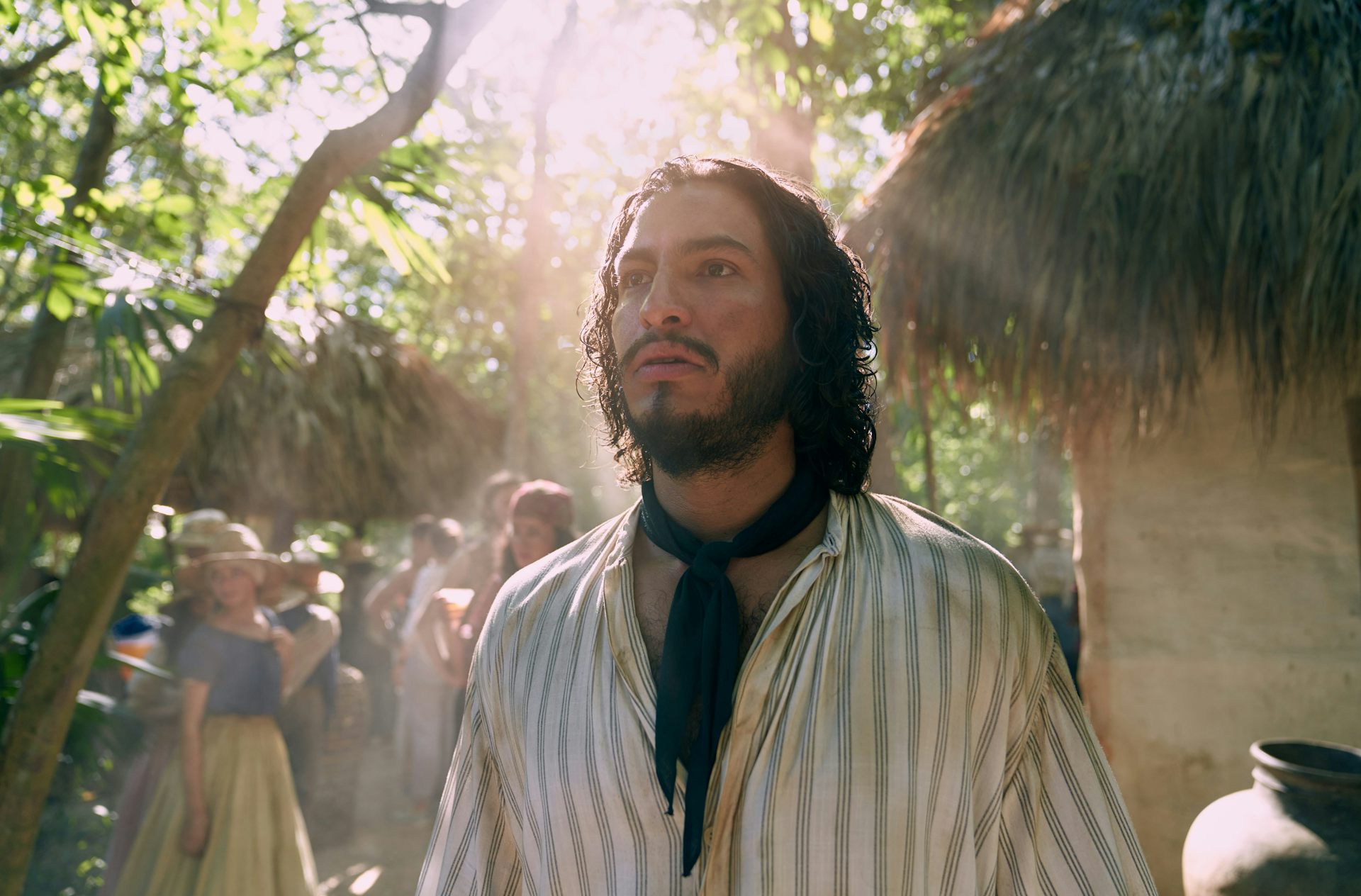 A bearded man stares into bright light as if haunted.