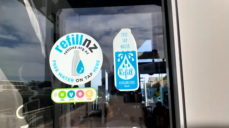 Stickers are posted on a glass door.