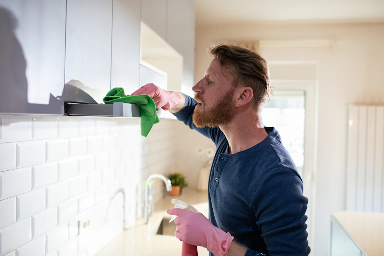 A man cleaning in the kitchen.