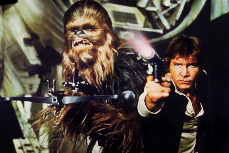 An ape and a man holding firearms