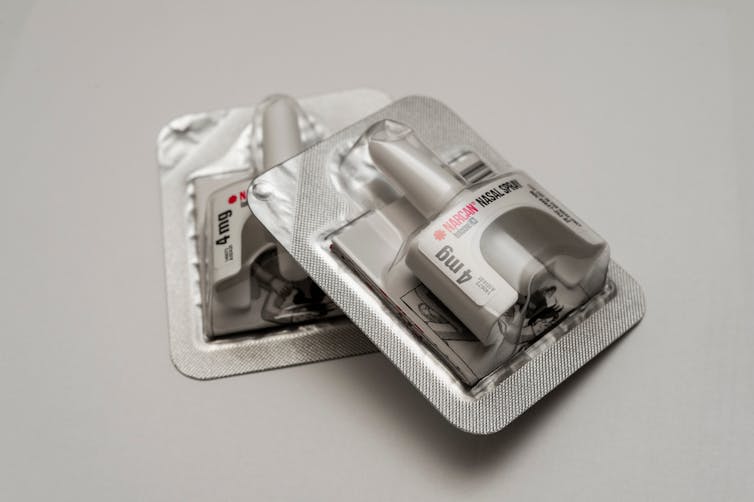 two nasal spray dispensers of Narcan in foil packaging