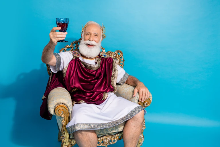 Ancient Greek or Roman sitting in chair, holding glass of red wine in hand, aloft