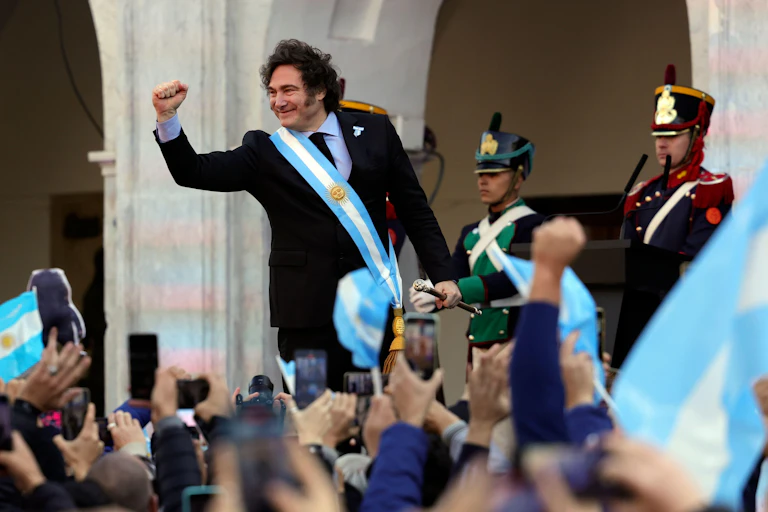 argentinian president javier milei raising closed fist to crowds