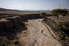 A very deep river, totally dry, dried out earth all around