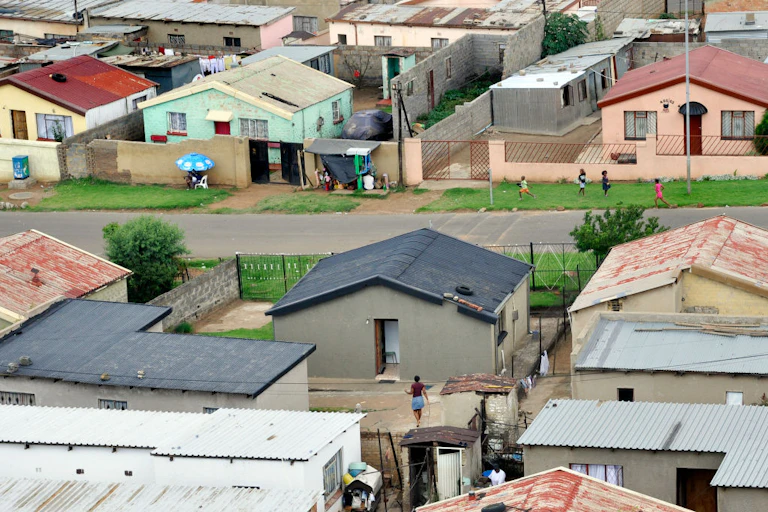 View from above of small houses with additional small buildings in the yards
