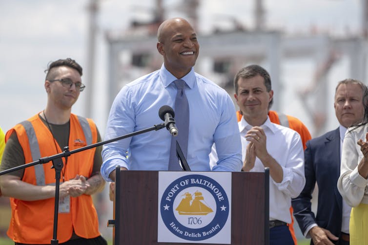 Maryland Governor Wes Moore speaks outdoors in front of a lectern.