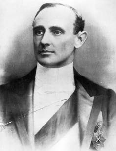 An old black and white portrait of a man in a suit