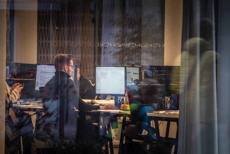 Office workers looking at computers.