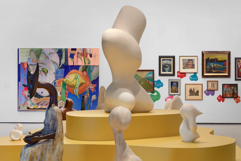 Different sculptures on a yellow plinth.