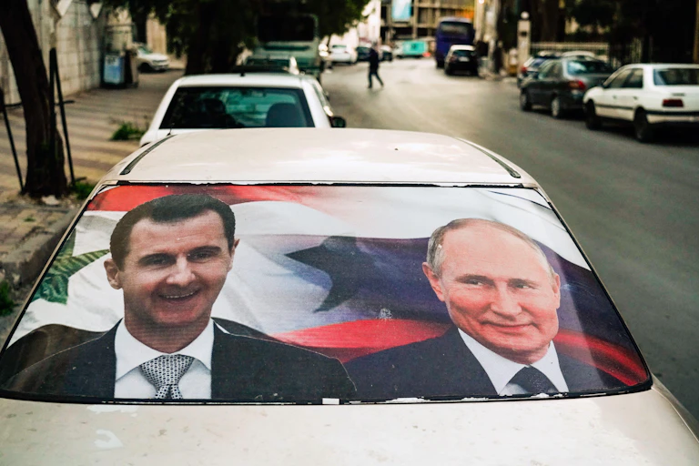 A poster with pictures of Syrian dictator Bashar al-Assad and Russian president Vladimir Putin.