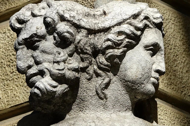A stone statue with two faces.