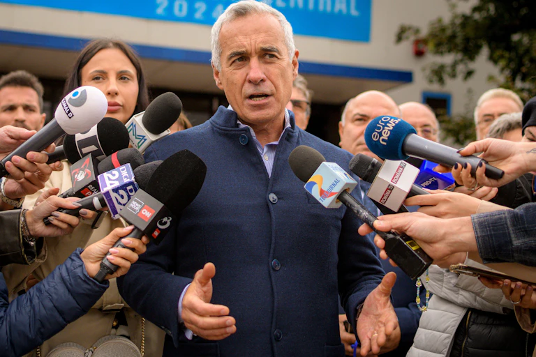 Calin Georgescu, a Romanian politician, surrounded by the media.