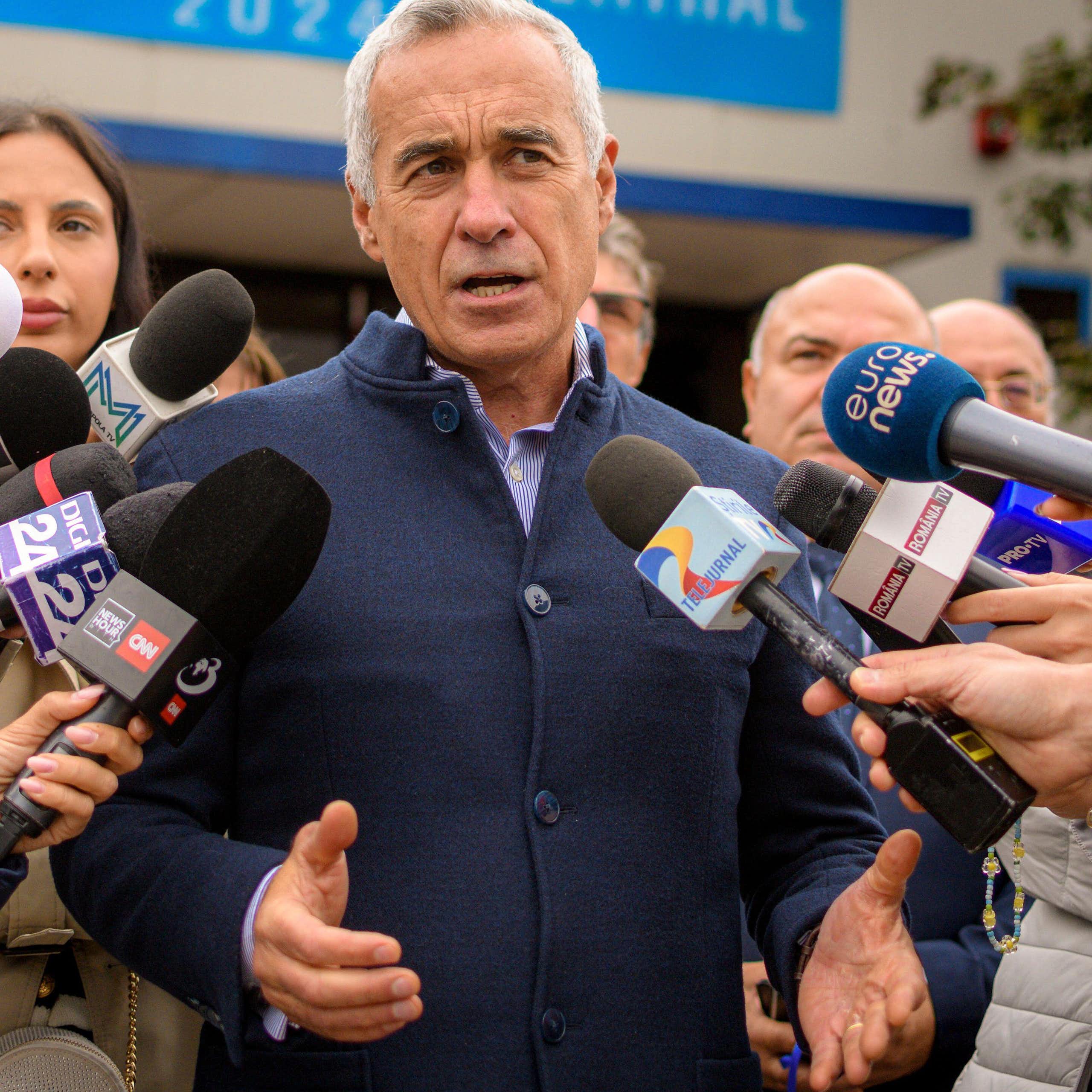 Calin Georgescu, a Romanian politician, surrounded by the media.