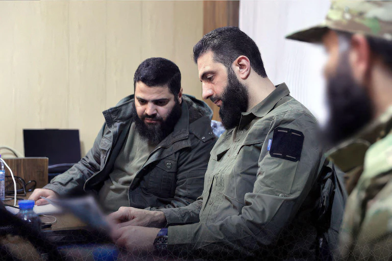 Syriuan rebel leader Abu Muhammad Al-Jolani with his aides.