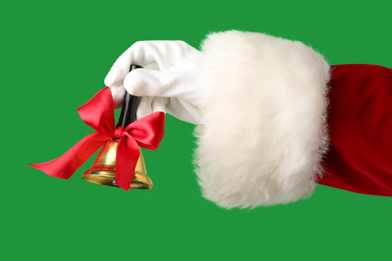 A white glove and furry cuff on a red sleeve rings a bell with a red ribbon.