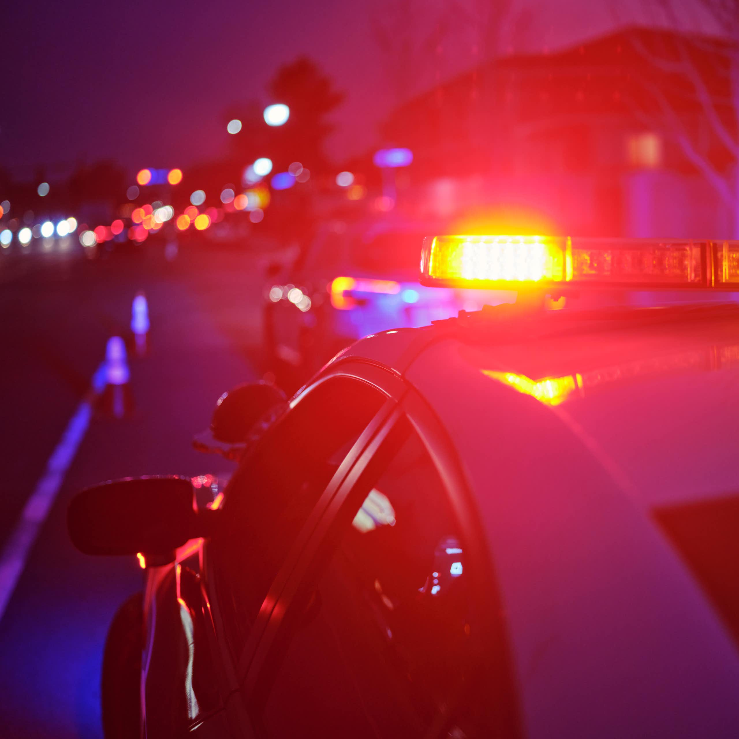 View of police cruiser's flashing lights in evening