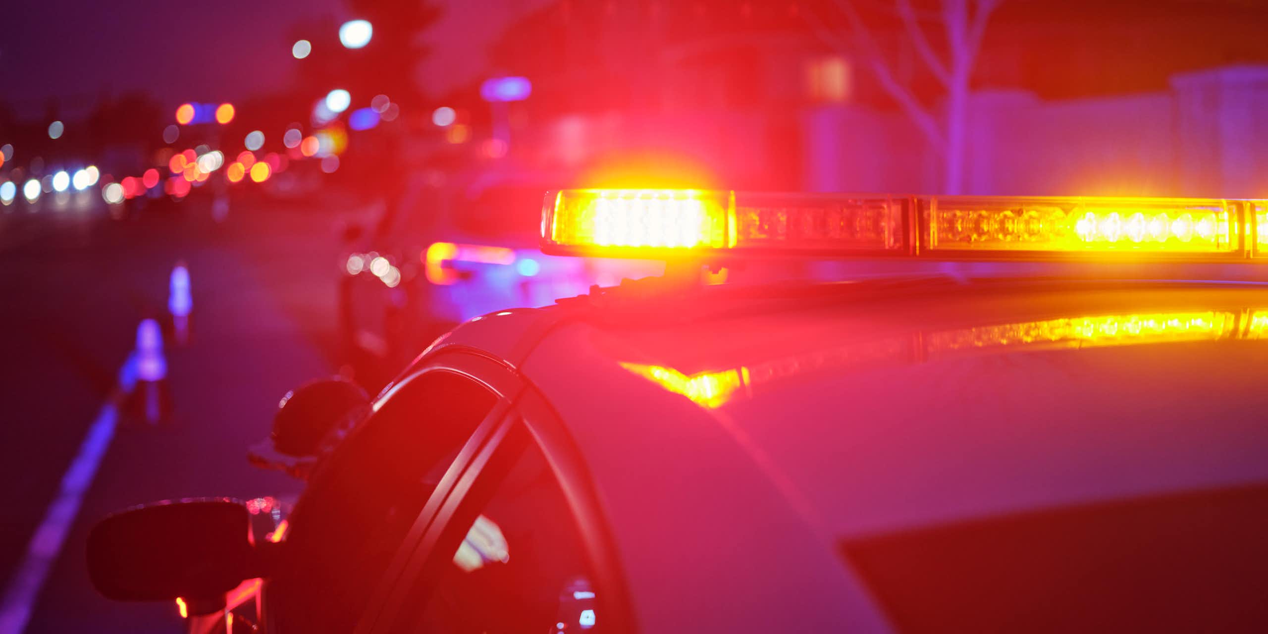 View of police cruiser's flashing lights in evening