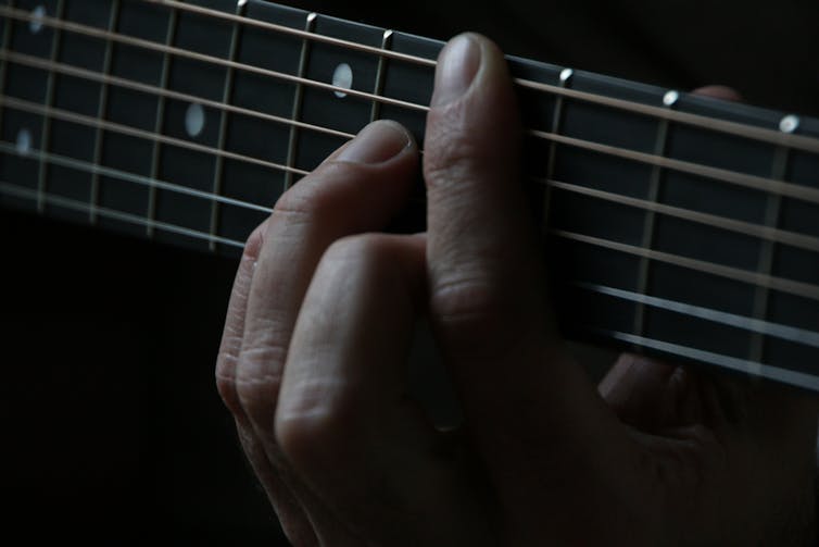 Person plays guitar