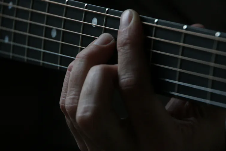 Person plays guitar