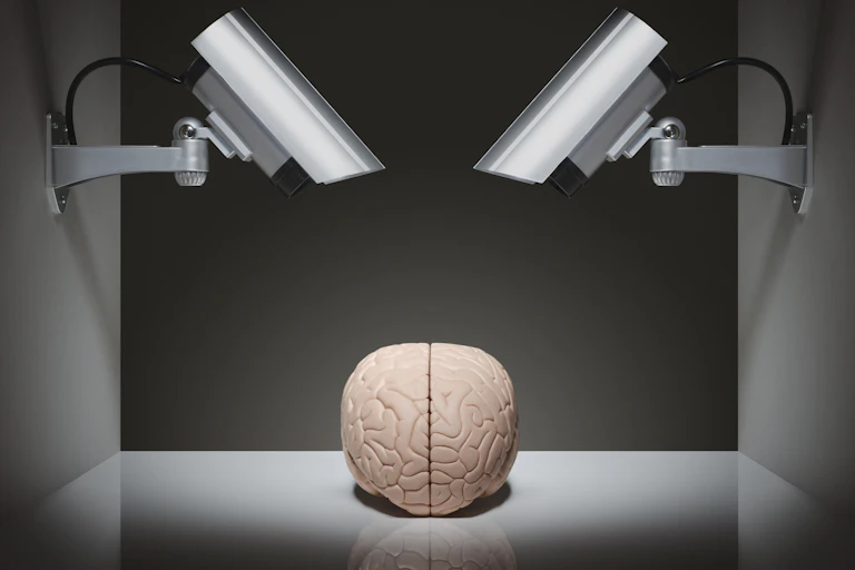 Illustration of two surveillance cameras trained down on a brain