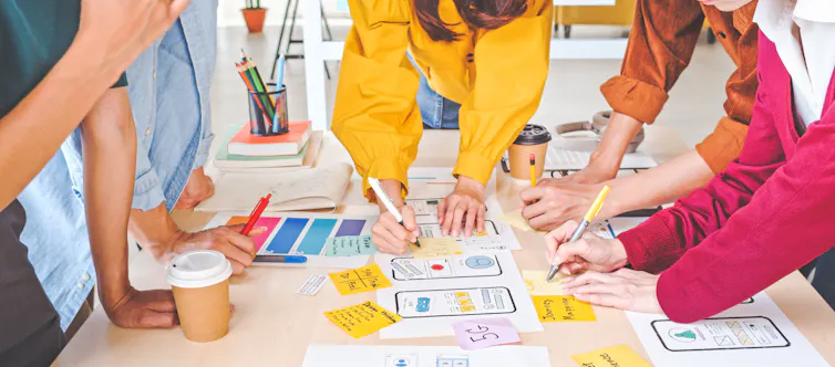 business creative team work together, writing on documents on a table