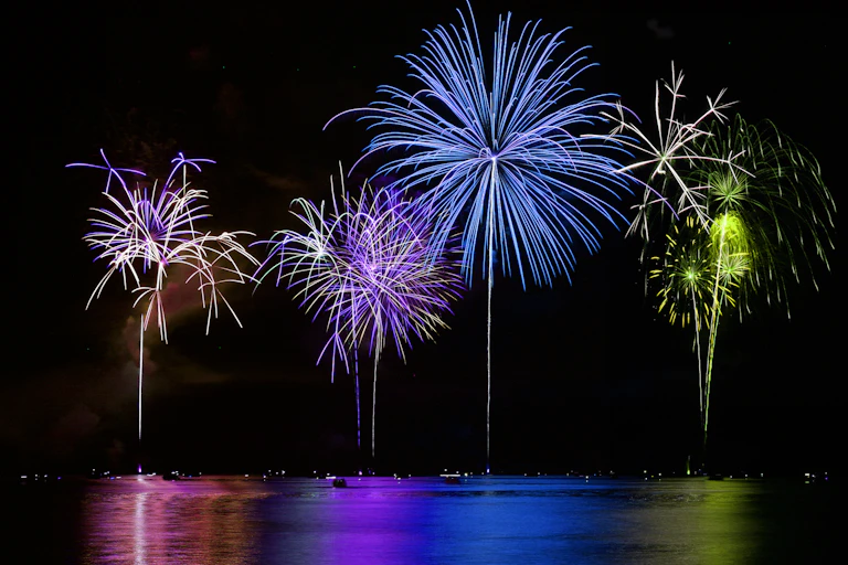 bright blue purple fireworks over lake